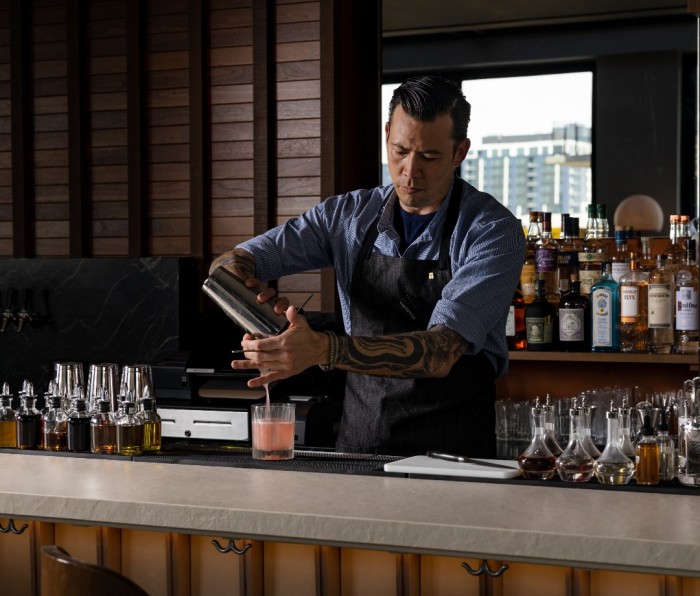 Bartender at Reynard Social at Thompson Denver prepares a Favorite Floral.